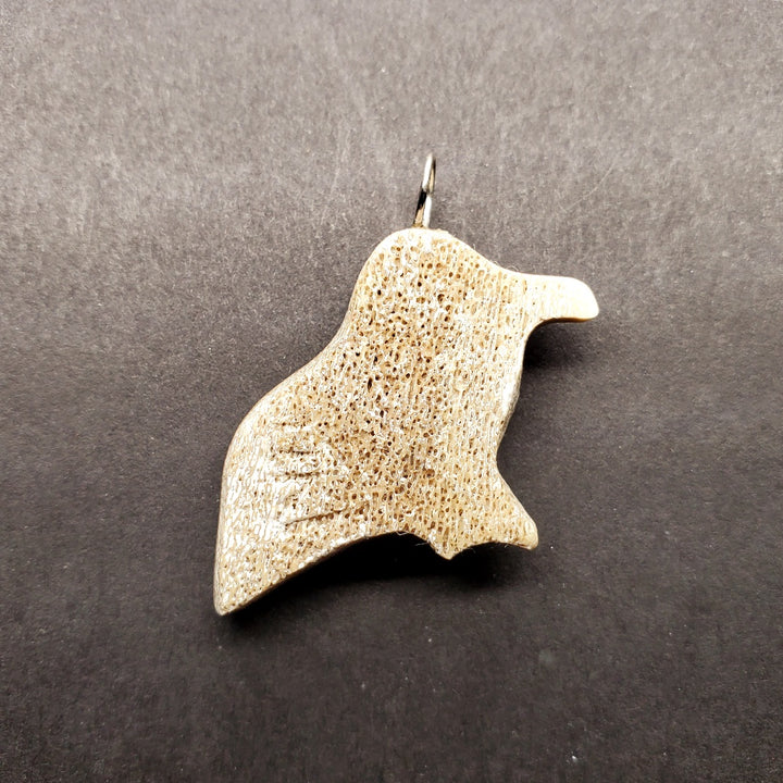 Bird pendant made from caribou antler.