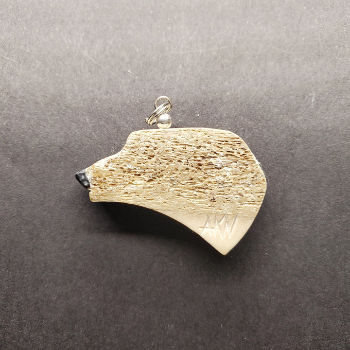 Polar bear head pendant in caribou antler.